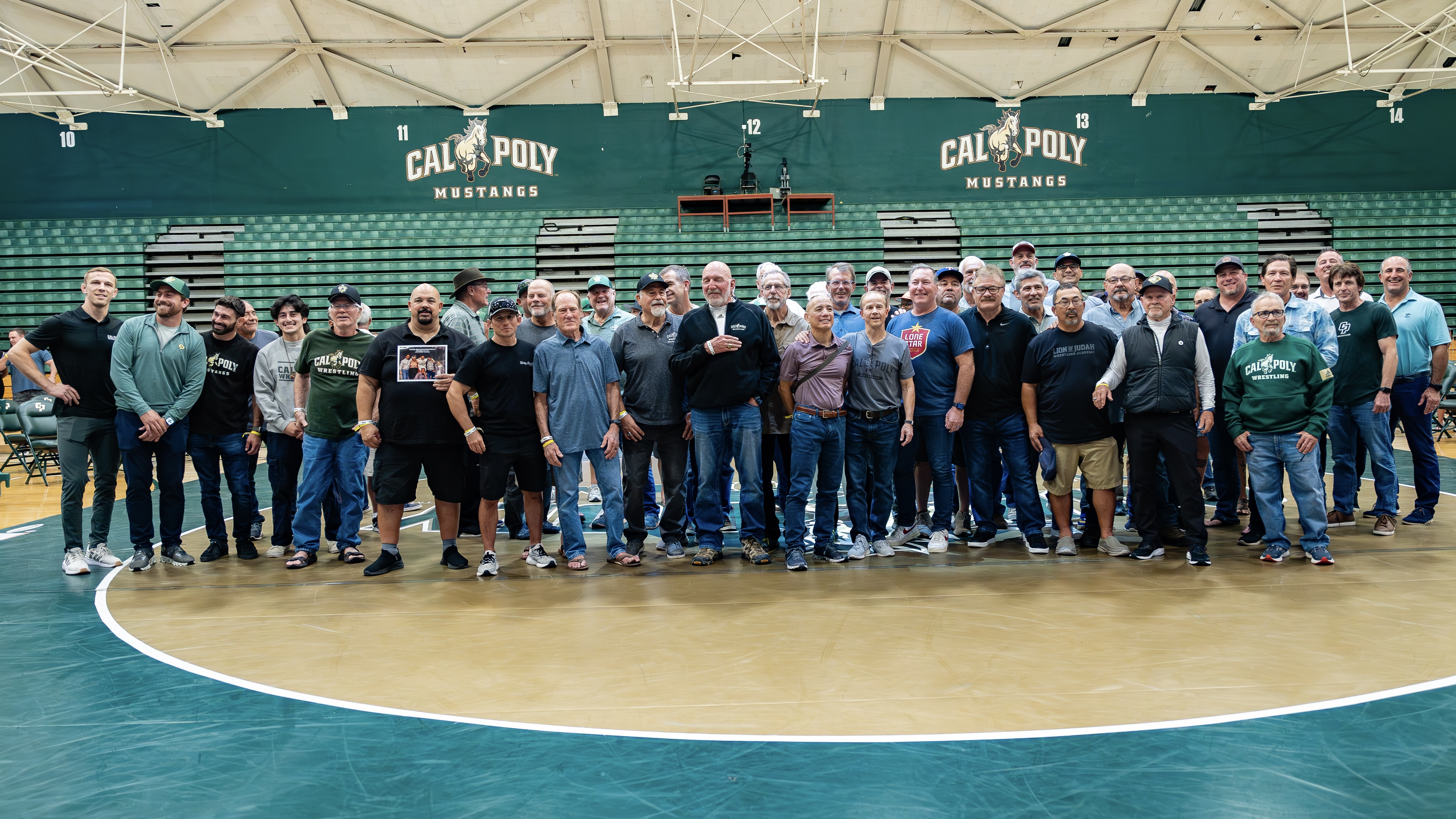 Cal Poly Wrestling alumni gathered on the mat at Mott Athletics Center