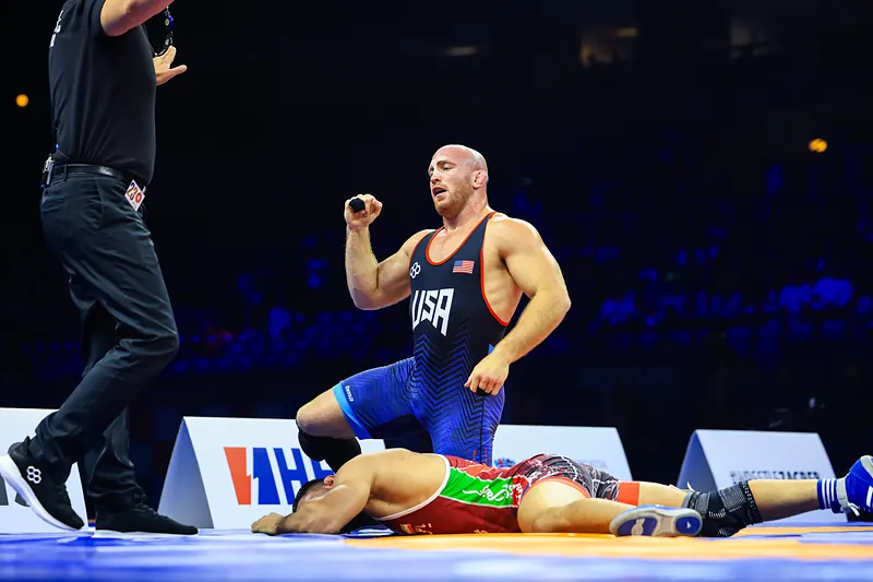 Kyle Snyder of Team USA on one knee after winning the 2025 world title at 97 kg