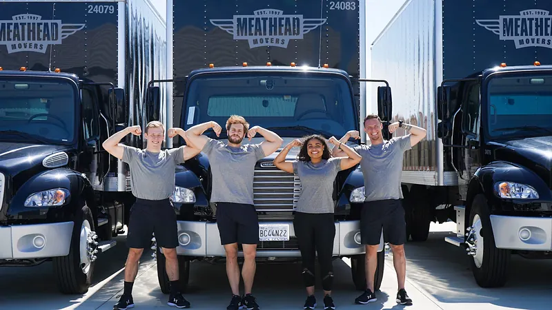 A Meathead Movers crew in front of their trucks