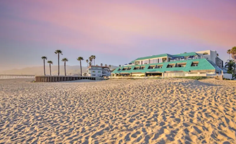 SeaVenture Beach Hotel on the sand in Pismo Beach at sunset