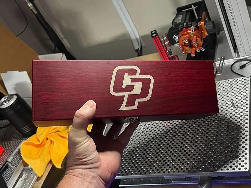 A Ginger Cuts rosewood finish wine box, shown here with the CP logo